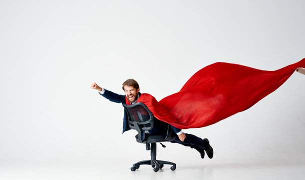 business man the hero in a red raincoat rolls on a chair on an isolated background