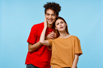 Naklejka premium young couple on a blue background colored t-shirts