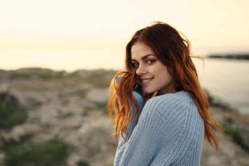 Fototapeta premium joyful woman smiling in a blanket sunset nature