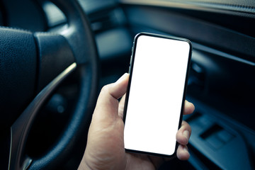 Man hand holding  smartphone with blank screen in the car