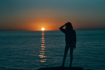 Fototapeta premium woman silhouette at sunset sea