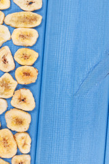Homemade dried chips of banana for snack or dessert, copy space for text