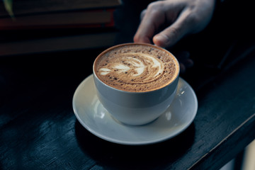 cup of coffee on wooden table