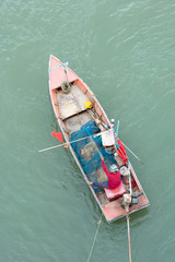 Fototapeta na wymiar fisherman on boat with net in hands
