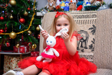 Concept portrait of a cute beautiful girl child in the new year with a gift