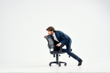business man riding his chair on a white isolated background