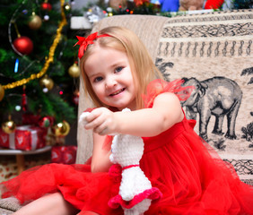 Concept portrait of a cute beautiful girl child in the new year with a gift