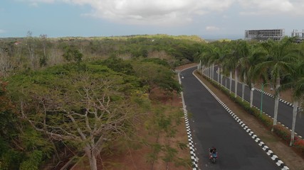 aerial drone photo of couple riding scooter. Bali island.