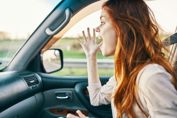 Fototapeta na wymiar surprised woman riding in the car