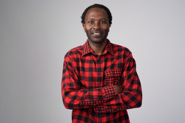 Portrait of happy African hipster man smiling with arms crossed
