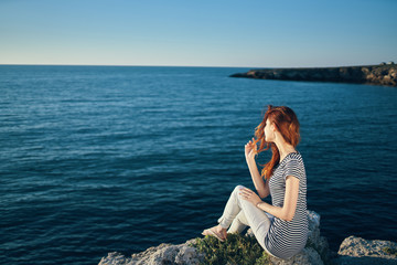 woman sitting on the seashore sun nature