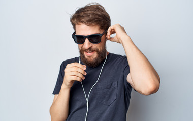 happy man with glasses and beard listening to music with headphones