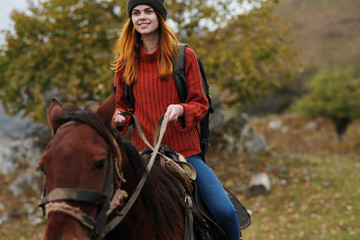 Fototapeta premium woman riding a horse nature