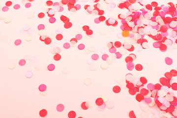 Confetti on pink background.
