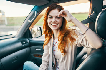 woman smiling sitting in a car trip
