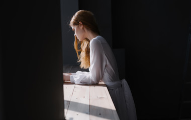 beautiful woman standing by the window