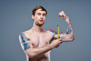 man measures his arms muscular