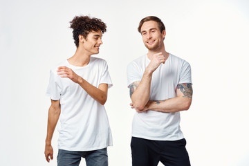 male friends in white t-shirts on an isolated logo background
