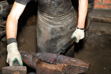 Blacksmith working on an anvil