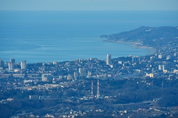 Panorama of the Sochi city from high mountain. Landscape. Blue sea and hills.