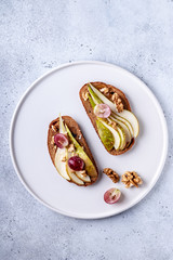 Toasts with pears and honey on a white background