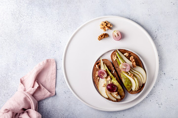 Toasts with pears and honey on a white background