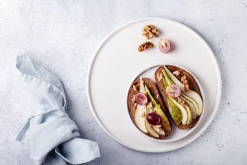 Toasts with pears and honey on a white background