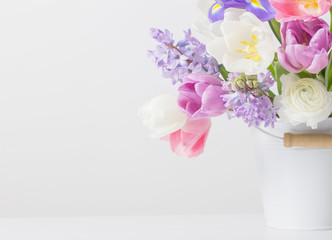 spring flowers in bucket on white  background