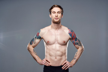Obraz premium strong man with a tattoo on the body muscular