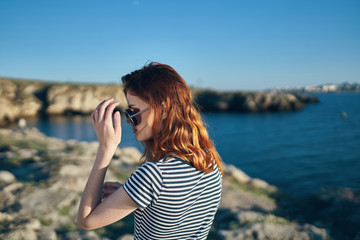 woman in sunglasses by the sea summer nature