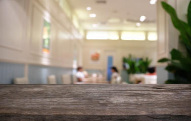 Empty dark wooden table in front of abstract blurred bokeh background of restaurant . can be used for display or montage your products.Mock up for space.