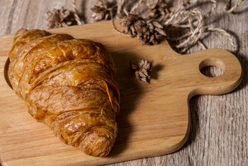 Fresh croissants on a wooden chopping board