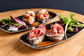 Sandwich with prosciutto, cheese and lettuce