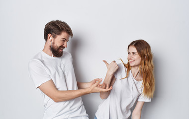 happy young couple in white t-shirts logo headphones smiles emotions