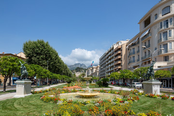 Fountain and flowers in a side street in Menton, south of France