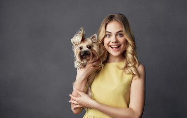 Fototapeta na wymiar joyful woman with a dog in her arms