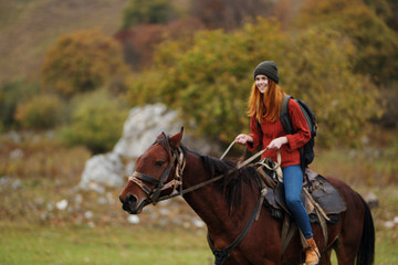 woman riding a horse in nature autumn