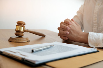 Legal counsel presents to the client a signed contract with gavel and legal law. justice and lawyer...