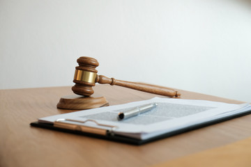 Legal counsel presents to the client a signed contract with gavel and legal law. justice and lawyer...