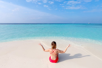 Young fashion woman relax on the beach. Happy island lifestyle. White sand, blue cloudy sky and crystal sea of tropical beach. Vacation at Paradise. Ocean beach relax, travel to Maldives islands