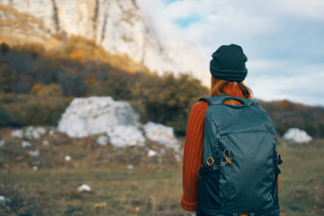 woman goes hiking with a backpack nature trip