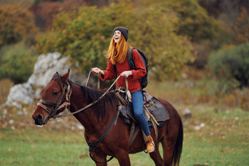 Obraz premium happy woman riding a horse nature autumn trip