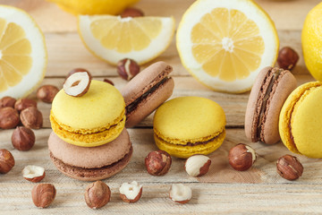 Yellow and brown french macarons with lemon and hazelnuts