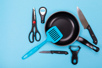 Close up picture of group of kitchen utensils with copyspace on blue background