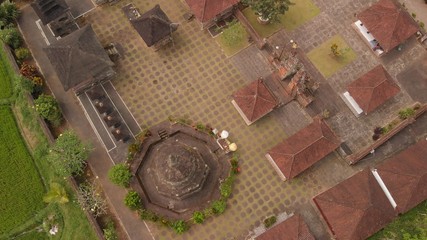 aerial photo of balinese temple among rice fields. Top view. Tropical island of Bali. Beautiful temple.