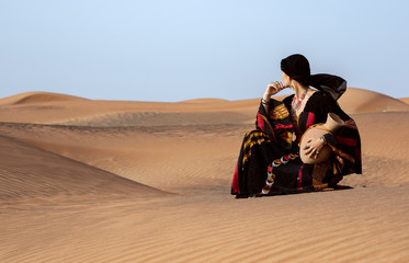 woman in a desert with a water dish