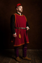 man (actor) in a 15th century costume (medieval) on an aged stylized background. Hobby,...