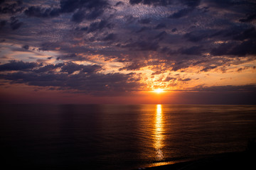 Beautiful yellow and purple sunset above the sea or the ocean, tropical resort