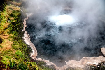 Fototapeta na wymiar Suphur Crater with smoke and vegetation