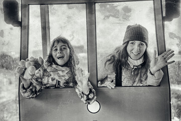 Happy mother and daughter smiling riding a train